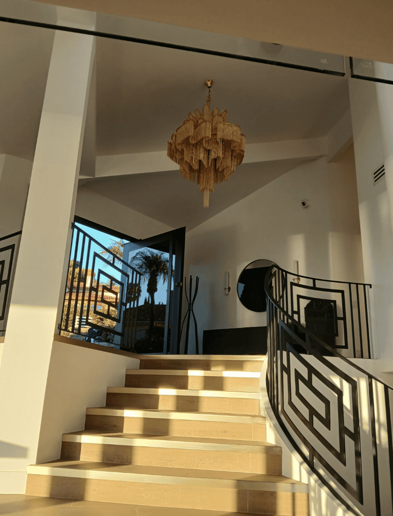 Luxurious staircase with modern decor and chandelier in a stylish interior.