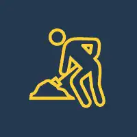 Construction worker digging with shovel for renovation project.